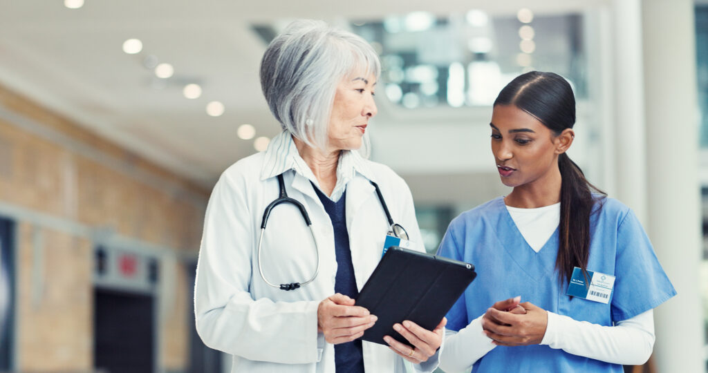 Women, nurse or doctor with tablet for research discussion or healthcare mentorship at hospital. Female people, intern or medical worker with technology for staff training on telehealth app at clinic.