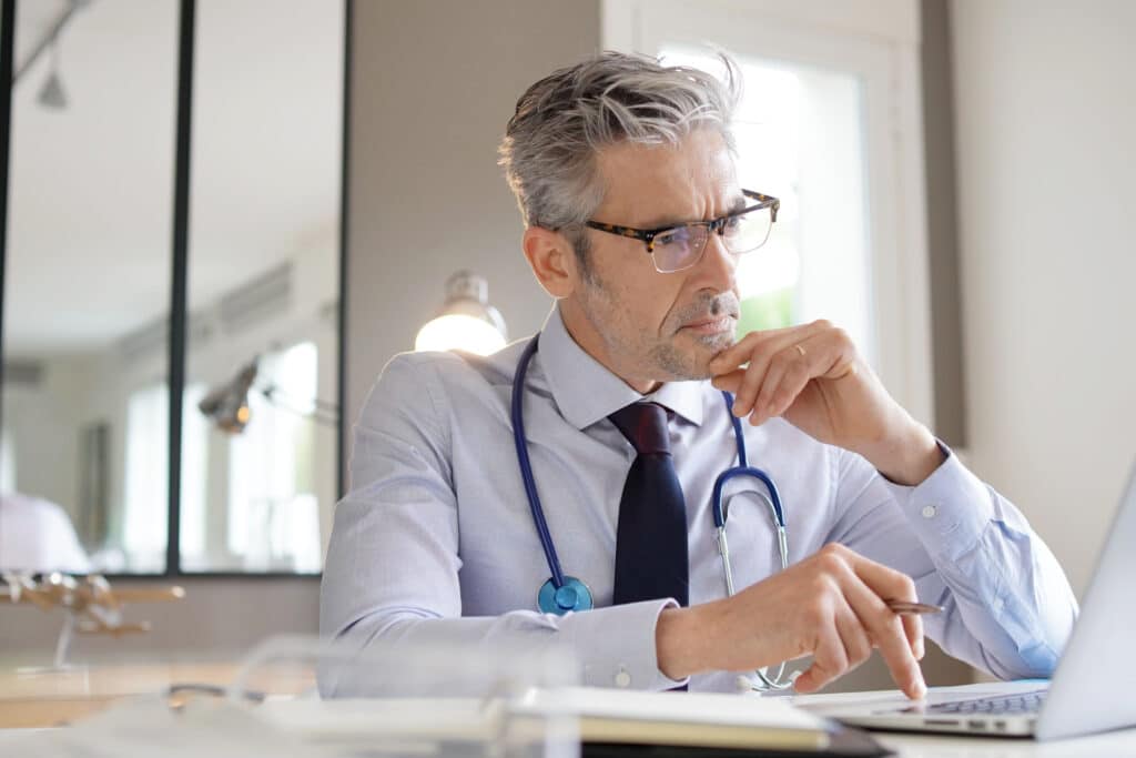 Medical professional reviewing AI-driven EHR insights.