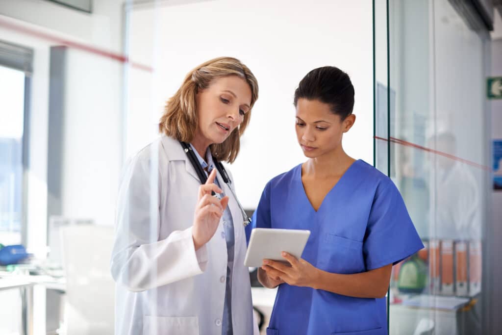 Shot of a female doctor giving a nurse instructions at a hospital.