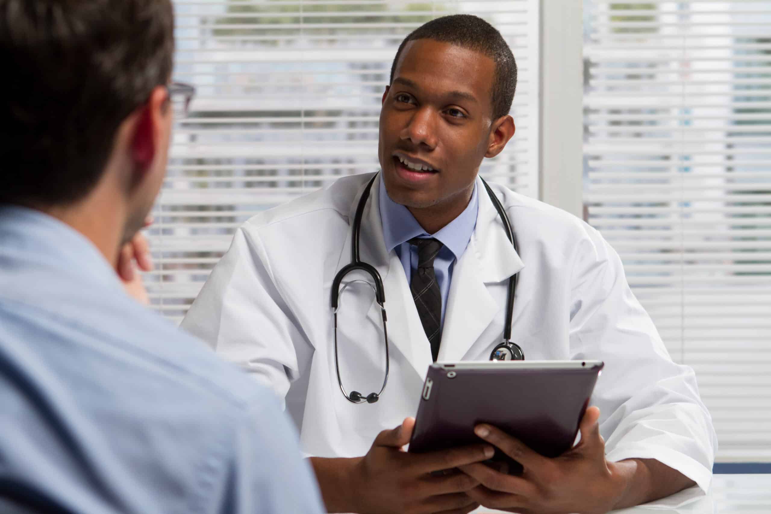 African American doctor with tablet and patient, horizontal