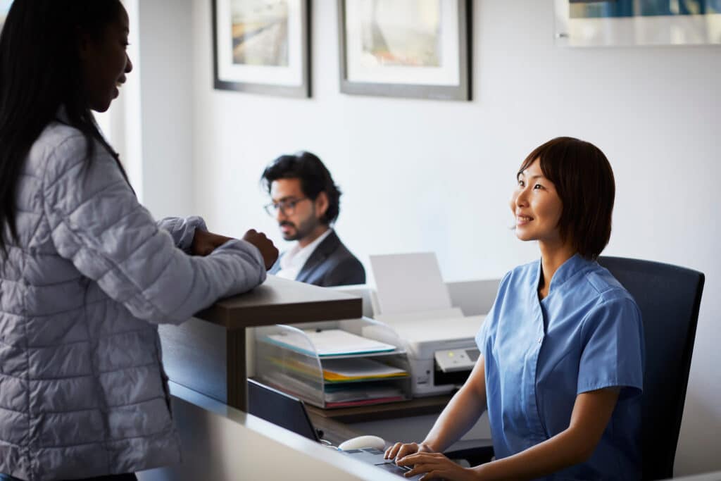 Healthcare professional assisting a patient with registration