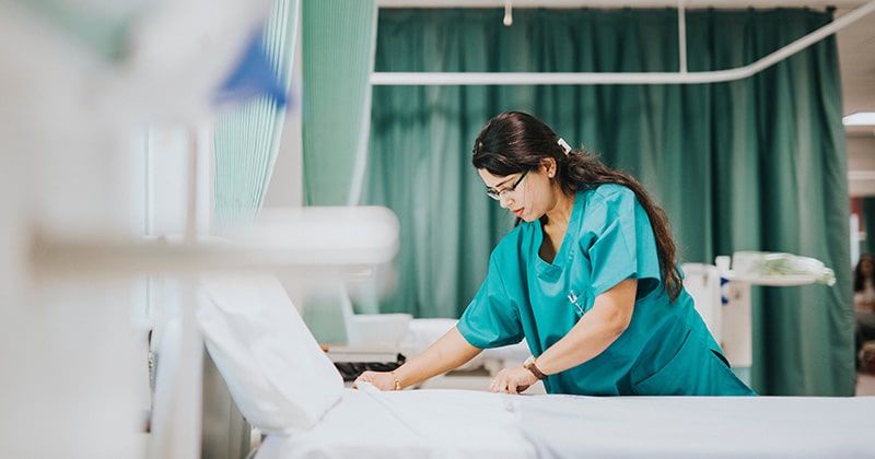 Nurse using technology to manage patient care more efficiently.